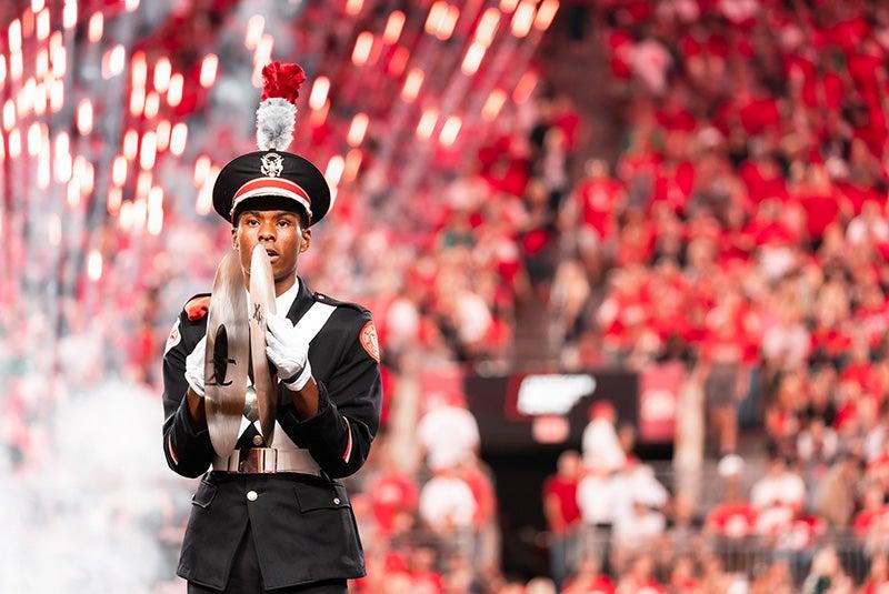 OSUMB percussionist playing cymbals on game day in the stadium